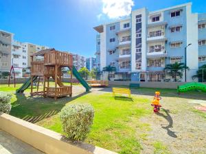 a park with a playground with a swing at The-Comfty-Spot Experience Sd Wifi in Santo Domingo