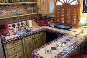 a kitchen with a counter with a sink and a microwave at Loft with rooftop deck in the Malecon - Unit #206 in Puerto Peñasco