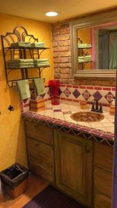 a bathroom with a sink and a mirror at Loft with rooftop deck in the Malecon - Unit #206 in Puerto Peñasco +58 photos