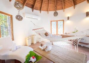 a woman laying in a hammock in a room at Sublimeluxcondo Terrenas Jaccuzibeachfront in Las Terrenas +58 photos