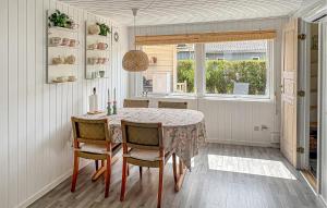a dining room with a table and chairs and a window at Gorgeous Home In Haderslev With Wifi in Haderslev