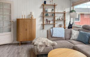 a living room with a couch and a book shelf at Gorgeous Home In Haderslev With Wifi in Haderslev