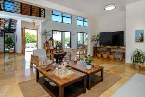 a living room with a table and a tv at Beach & Mountain Villaterrenaspoolbbq6Br in Las Terrenas