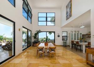a kitchen and dining room with a table and chairs at Beach & Mountain Villaterrenaspoolbbq6Br in Las Terrenas
