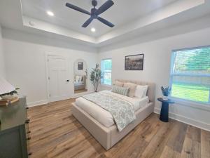 a bedroom with a bed and a ceiling fan at Pensacola Florida in Pensacola