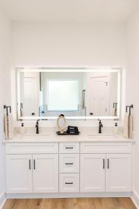 a white bathroom with two sinks and a large mirror at Pensacola Florida in Pensacola +35 photos