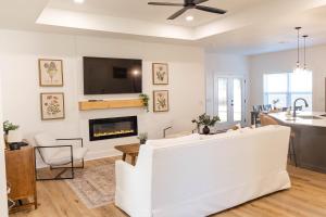 a living room with a white couch and a fireplace at Pensacola Florida in Pensacola