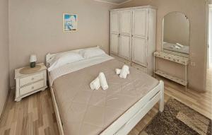 a bedroom with a bed with two towels on it at Gorgeous Home In Primosten in Primošten