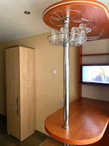 a metal pole in a room with a television at Klaipeda City in Klaipėda