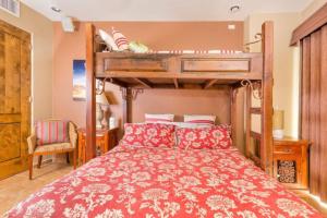 a bedroom with a bunk bed with a red bedspread at Bella Sirena 305-A - Elegant Oceanview Condo on Beachfront Resort in Puerto Peñasco +76 photos