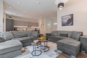 a living room with a couch and a table at 3 Bed Duplex, Pool Table, 4 Stops to Wembley in Hatch End