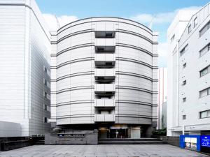 a white building with balconies on the side of it at HOTEL MYSTAYS Tachikawa in Tachikawa