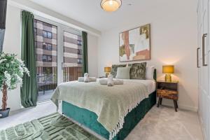 a bedroom with a bed and a large window at 3 Bed Duplex, Pool Table, 4 Stops to Wembley in Hatch End