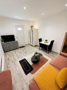 a living room with a couch and a table at Studio Zoo & Châteaux in Faverolles-sur-Cher