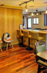 a living room with a bar and a table and chairs at 神乃宿 in Shimonoseki