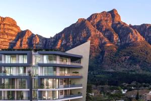 a building with a mountain in the background at Newlands Peak Luxury Suite in Cape Town