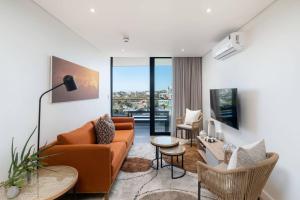 a living room with a couch and a table at Newlands Peak Luxury Suite in Cape Town