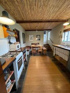 a kitchen with a table and a dining room at Love Nest In Pringle Bay in Pringle Bay