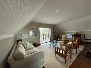 a living room with a couch and a table at Love Nest In Pringle Bay in Pringle Bay