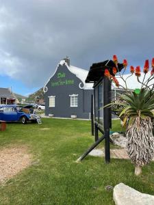 a blue car parked in front of a blue building at Love Nest In Pringle Bay in Pringle Bay