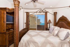 a bedroom with a large bed with a television at Bella Sirena 601-B -Stylish Condo in Oceanfront Resort in Puerto Peñasco +71 photos