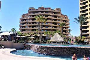a resort with a swimming pool and a building at Bella Sirena 601-B -Stylish Condo in Oceanfront Resort in Puerto Peñasco