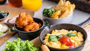 a table topped with bowls of food and other foods at HOTEL MYSTAYS Tachikawa in Tachikawa