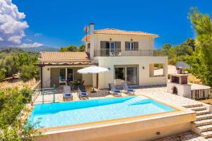 a villa with a swimming pool in front of a house at Villa Eudora in Tsoukalades