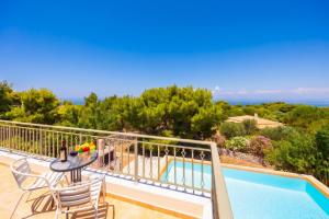 a view from the balcony of a villa with a swimming pool at Villa Eudora in Tsoukalades