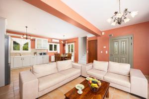 a living room with a couch and a table at Villa Eudora in Tsoukalades