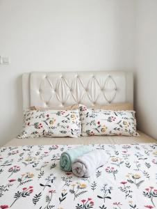 a bed with a blanket and pillows on it at Eden Vista in Kuantan