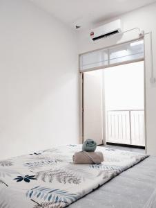 a bedroom with a bed with a pillow and a window at Eden Vista in Kuantan +5 photos