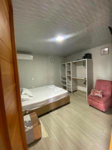 a small room with a bed and a chair at La posada in Nuquí +21 photos