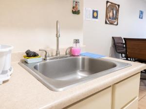 a stainless steel kitchen sink in a kitchen at 30 seconds beach aparment in Aguacate +30 photos