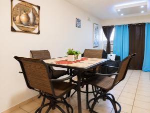 a dining room with a table and chairs at 30 seconds beach aparment in Aguacate