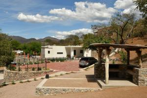 a car parked in a parking lot next to a building at Casa de Cuatro Vientos in Álamos