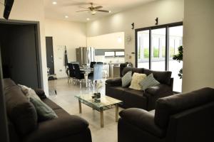 a living room with two couches and a table at Casa de Cuatro Vientos in Álamos