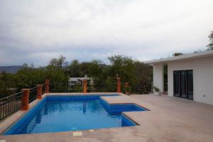 a swimming pool with blue water on a patio at Casa de Cuatro Vientos in Álamos