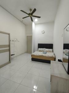 a bedroom with a bed and a ceiling fan at Eden Vista in Kuantan