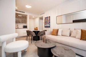a living room with a white couch and a table at 1 Br Apartment In Shaul Adler in Jerusalem