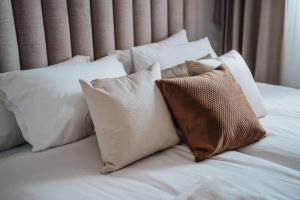 a white bed with white pillows on it at 1 Br Apartment In Shaul Adler in Jerusalem
