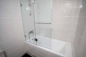 a shower with a glass door in a bathroom at 1 Br Apartment In Shaul Adler in Jerusalem +18 photos