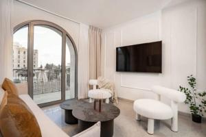 a living room with a couch and a tv at 1 Br Apartment In Shaul Adler in Jerusalem