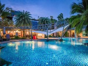 a large swimming pool with a bridge over it at R-Mar Resort and Spa Patong, Phuket in Patong Beach