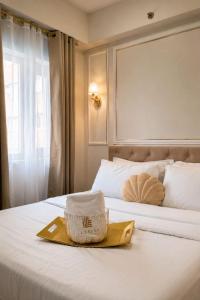 a hotel room with a bed with a basket on it at LuxeInn in Trece Martires
