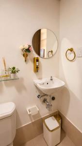 a white bathroom with a sink and a mirror at LuxeInn in Trece Martires