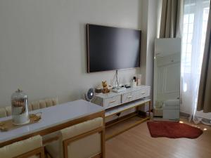 a living room with a flat screen tv on a wall at LuxeInn in Trece Martires +6 photos