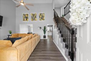 a living room with a couch and a staircase at Hollywood Hideaway in Clarksville