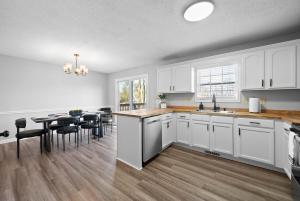 a kitchen with white cabinets and a table with chairs at Hollywood Hideaway in Clarksville