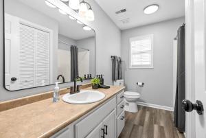 a bathroom with a sink and a toilet at Hollywood Hideaway in Clarksville +53 photos